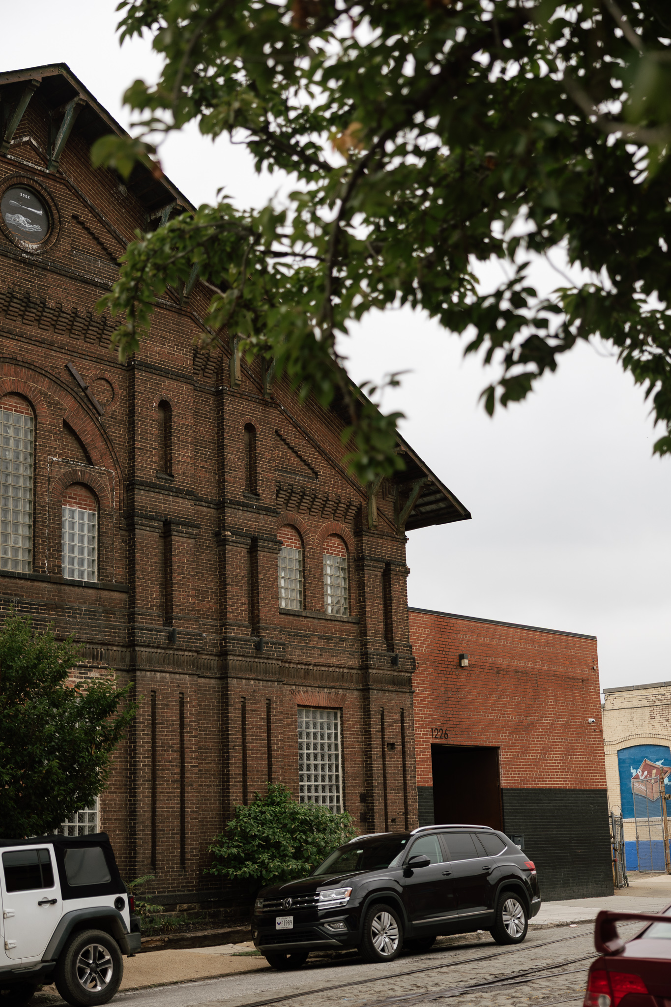 old historic red brick building on overcast day by Sharp Impressions Photo