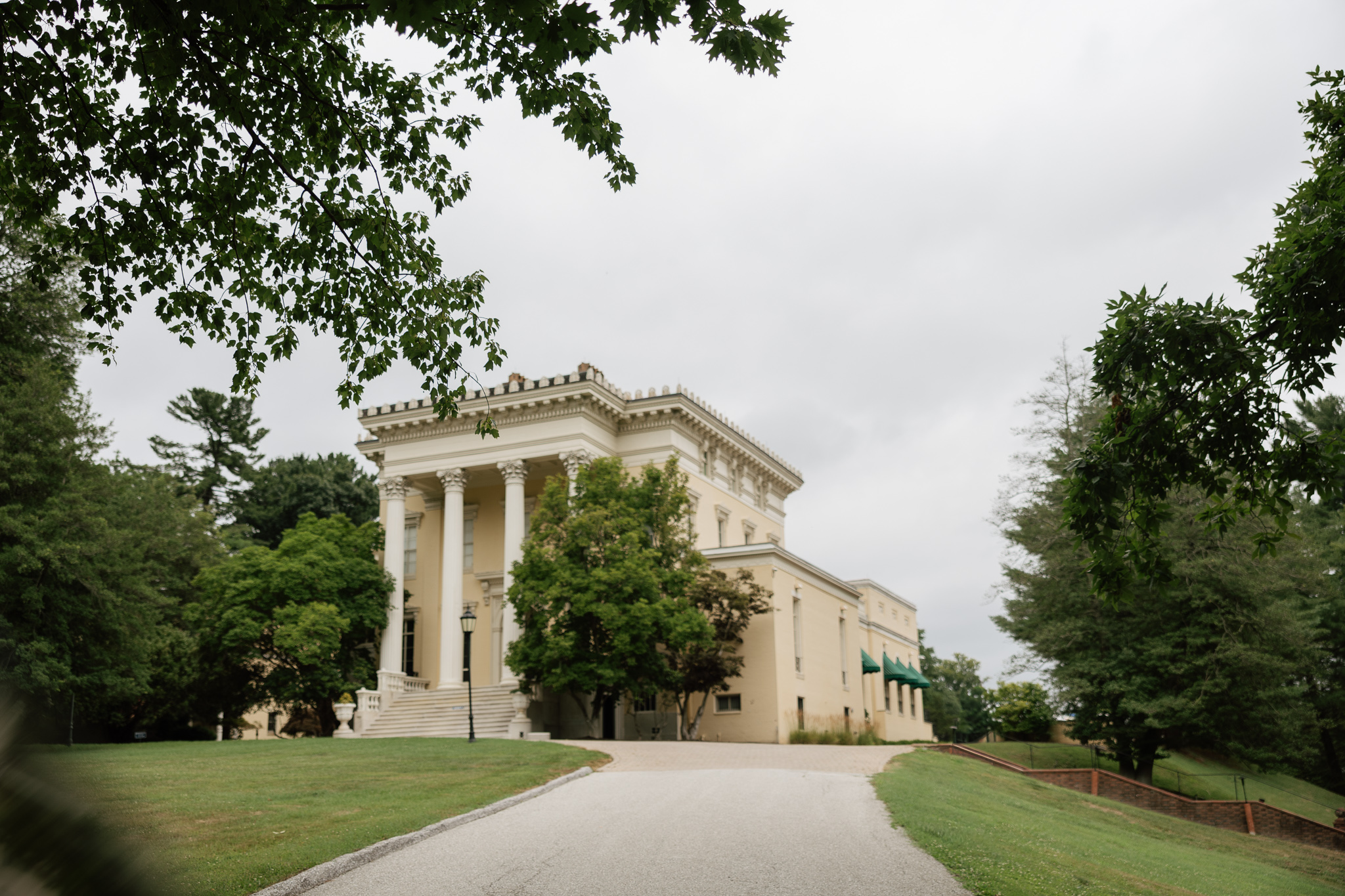 big white historic building on sweeping lawn showing best wedding venues in Maryland
