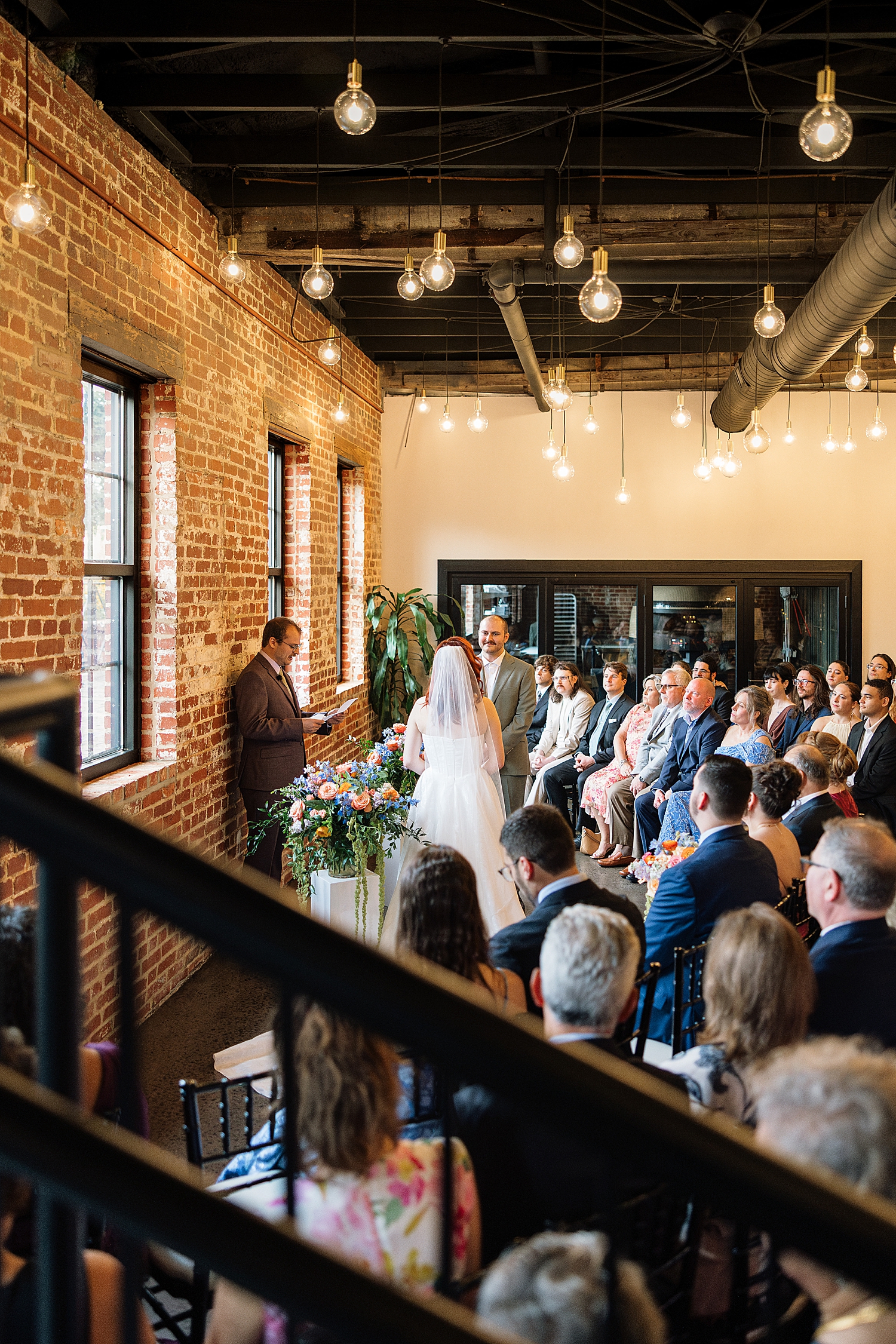 couple stands in front of friends to say I Do at Union Mills Public House