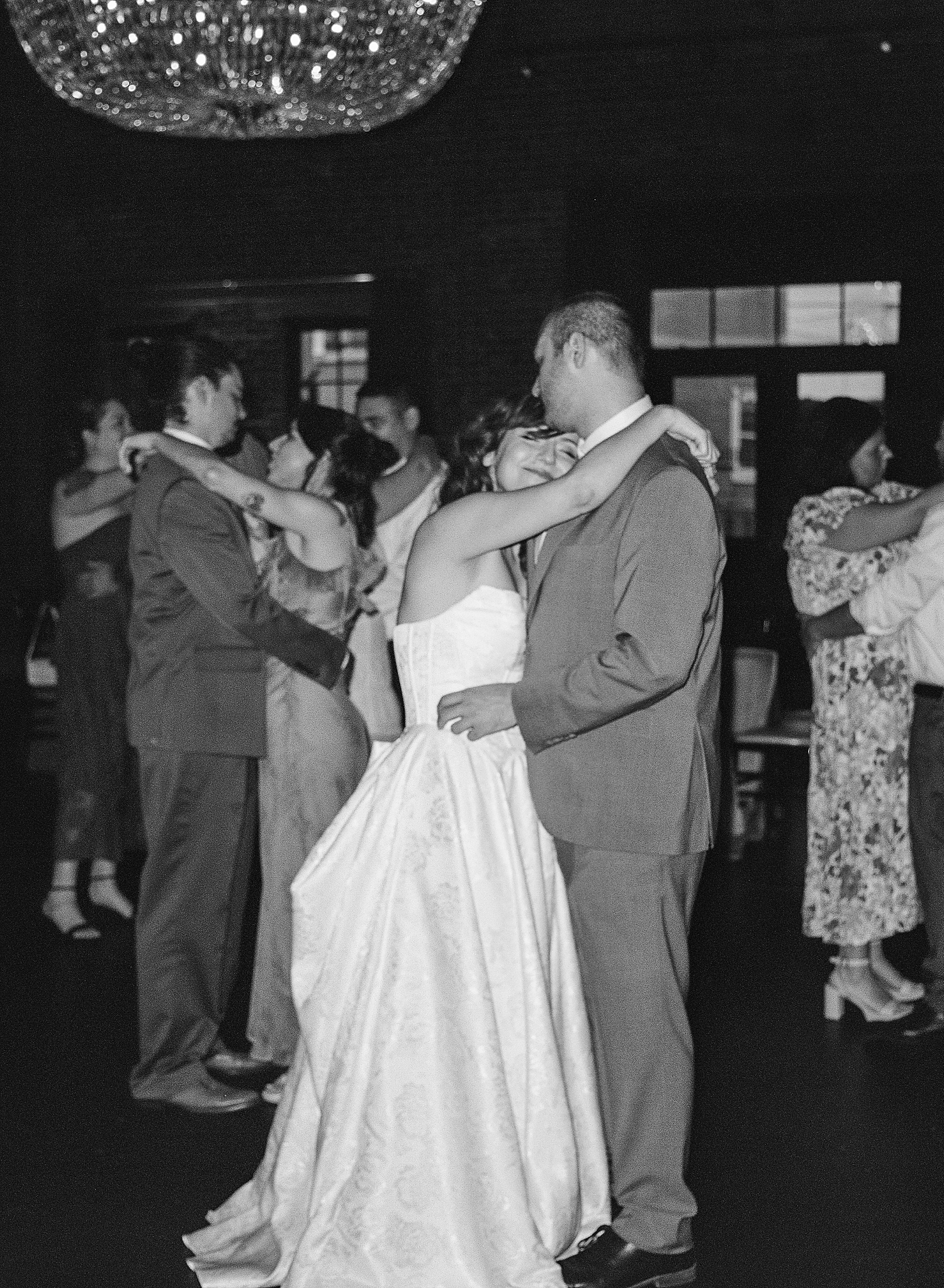 newlyweds snuggle and dance at reception by Maryland wedding photographer