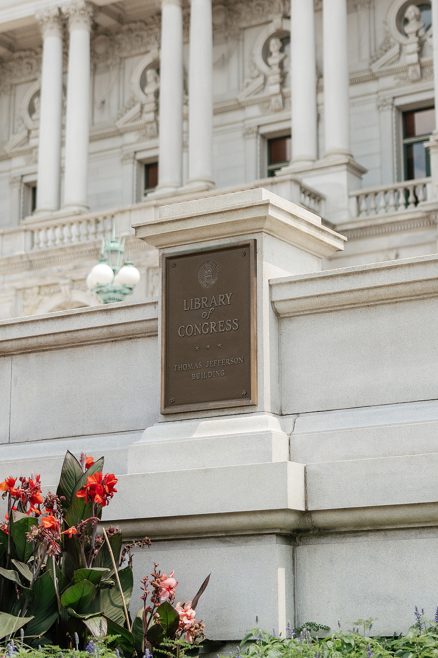 plaque for historic location on white stone building by Sharp Impressions Photo
