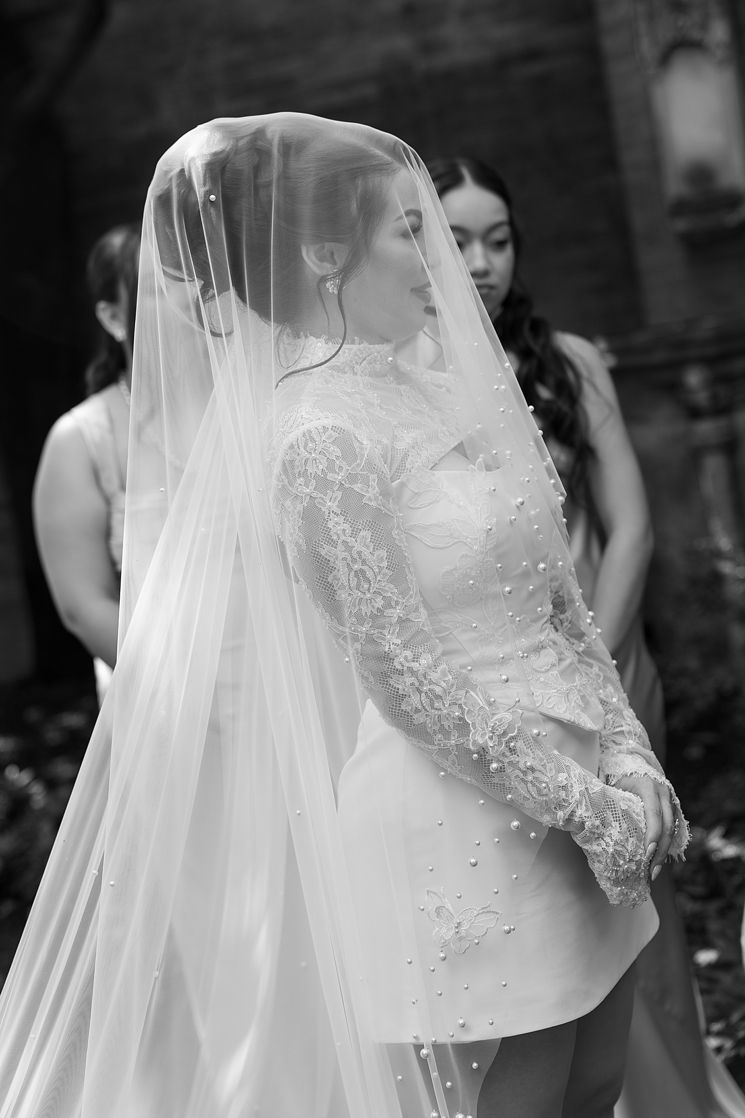 bride with veil over her in short dress outside for Anderson House Elopement