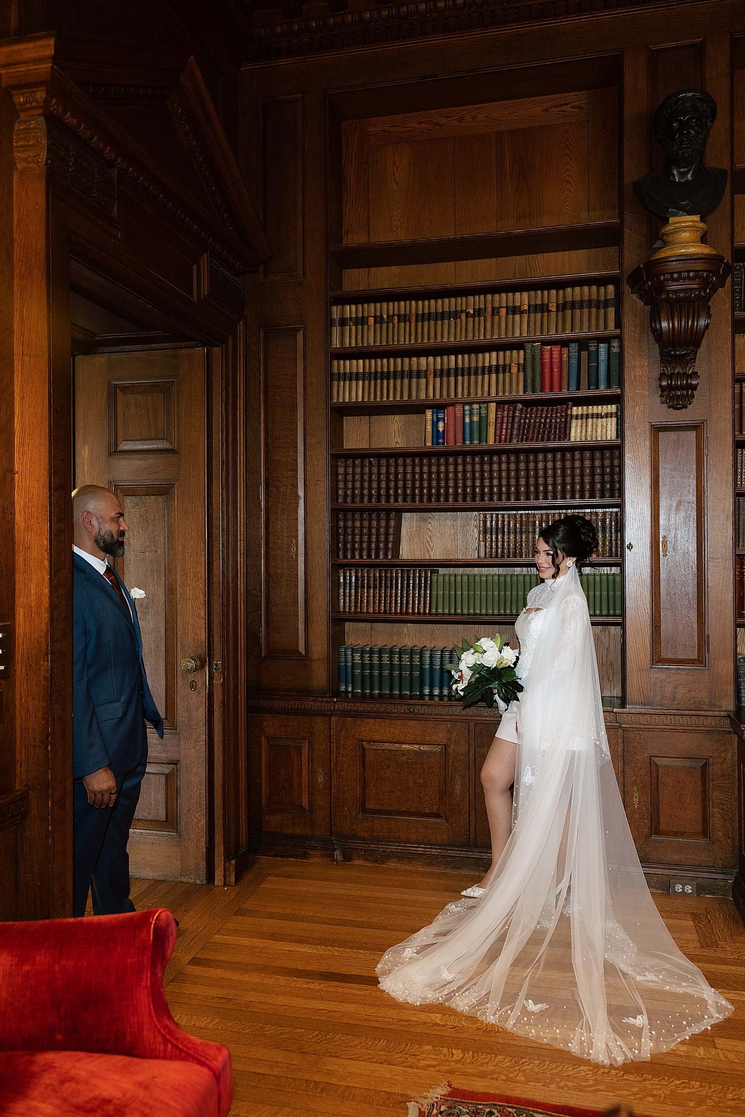bride and groom stand across library by Maryland wedding photographer