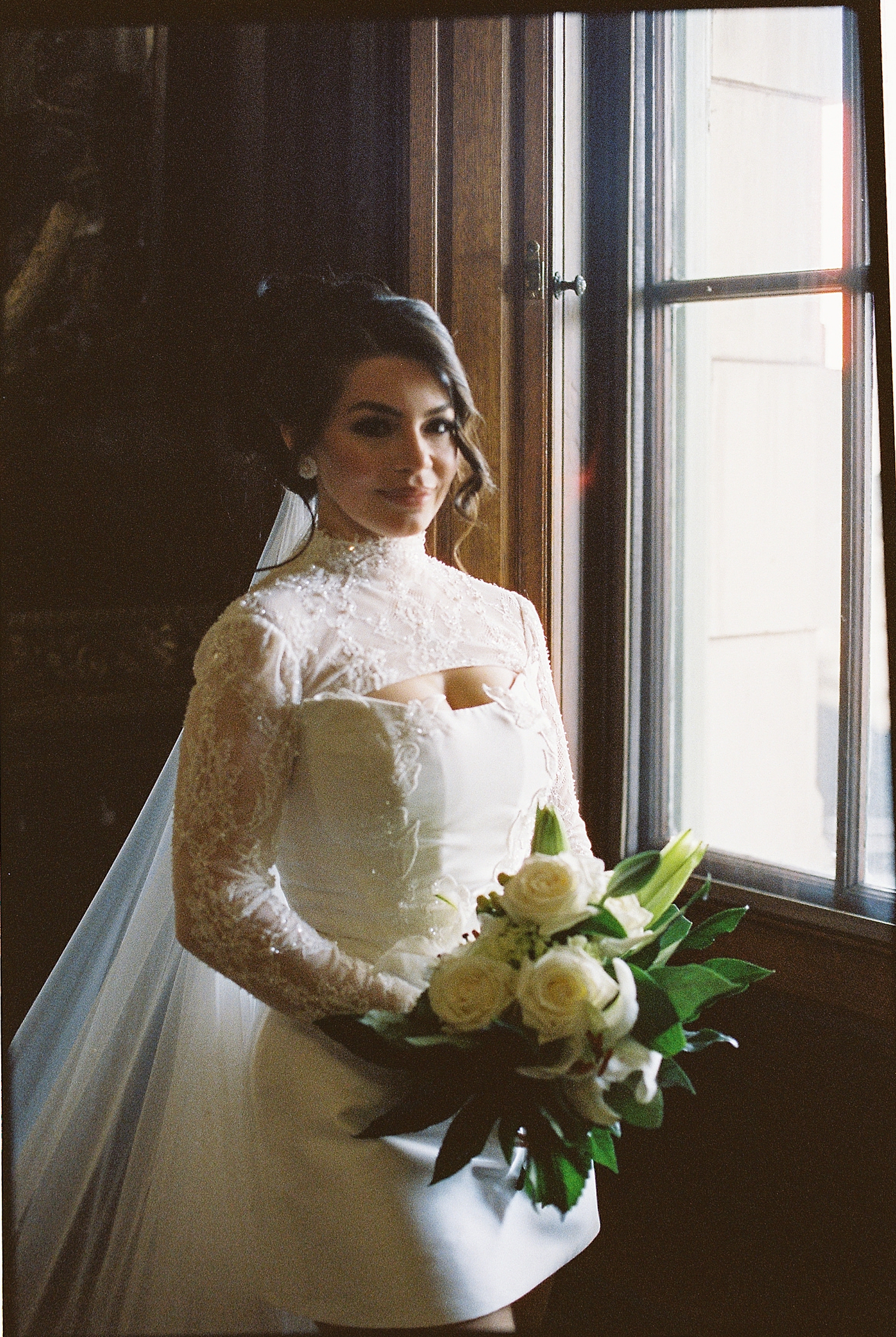 brunette bride in vintage mini dress by window for Anderson House Elopement