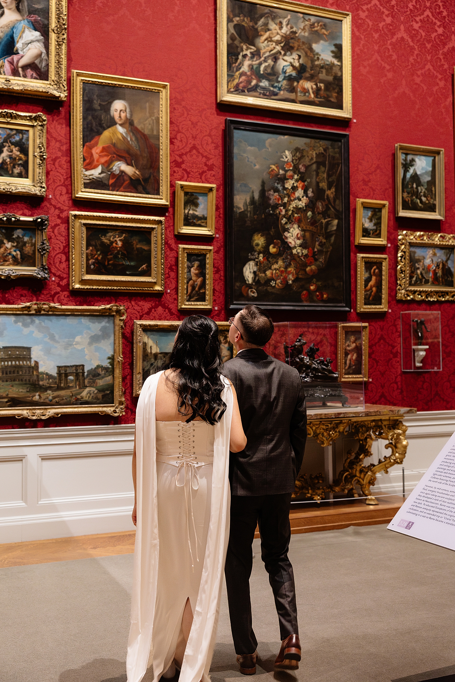 couple look at paintings in gallery showing Engagement Session Locations in Baltimore