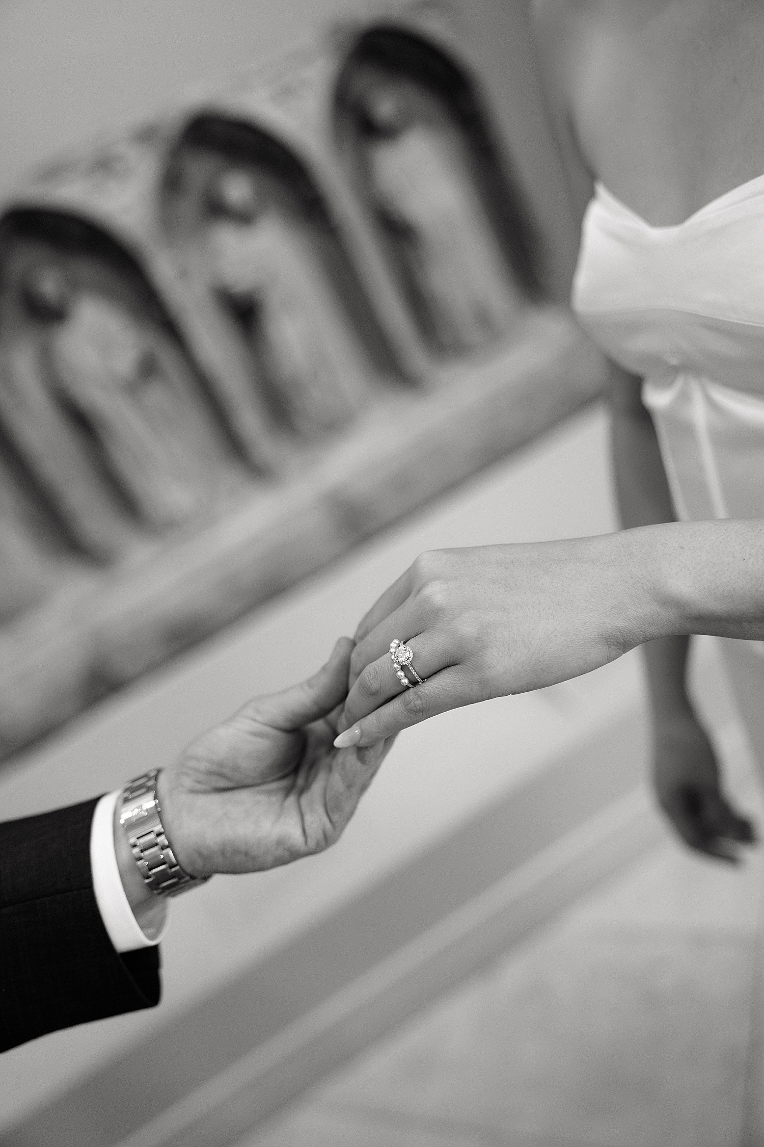 couple holds hands lightly, showing off diamond ring by Maryland wedding photographer