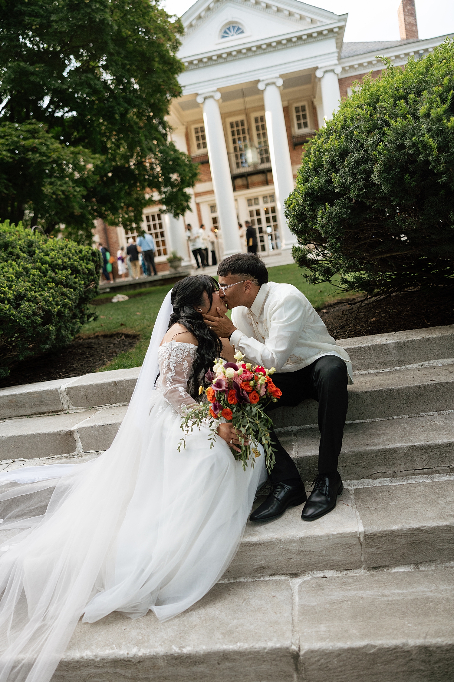 man and woman kiss on steps by Sharp Impressions Photography